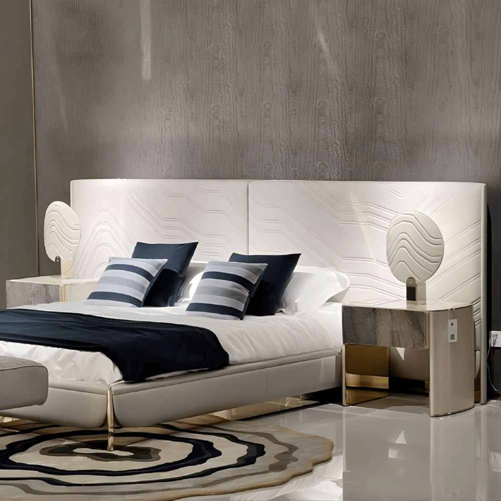 Modern Luxury Designer Bed in white leather with navy bedding and marble nightstands in a sleek interior Modern Luxury Designer Bed in white leather with navy bedding and marble nightstands in a sleek interior